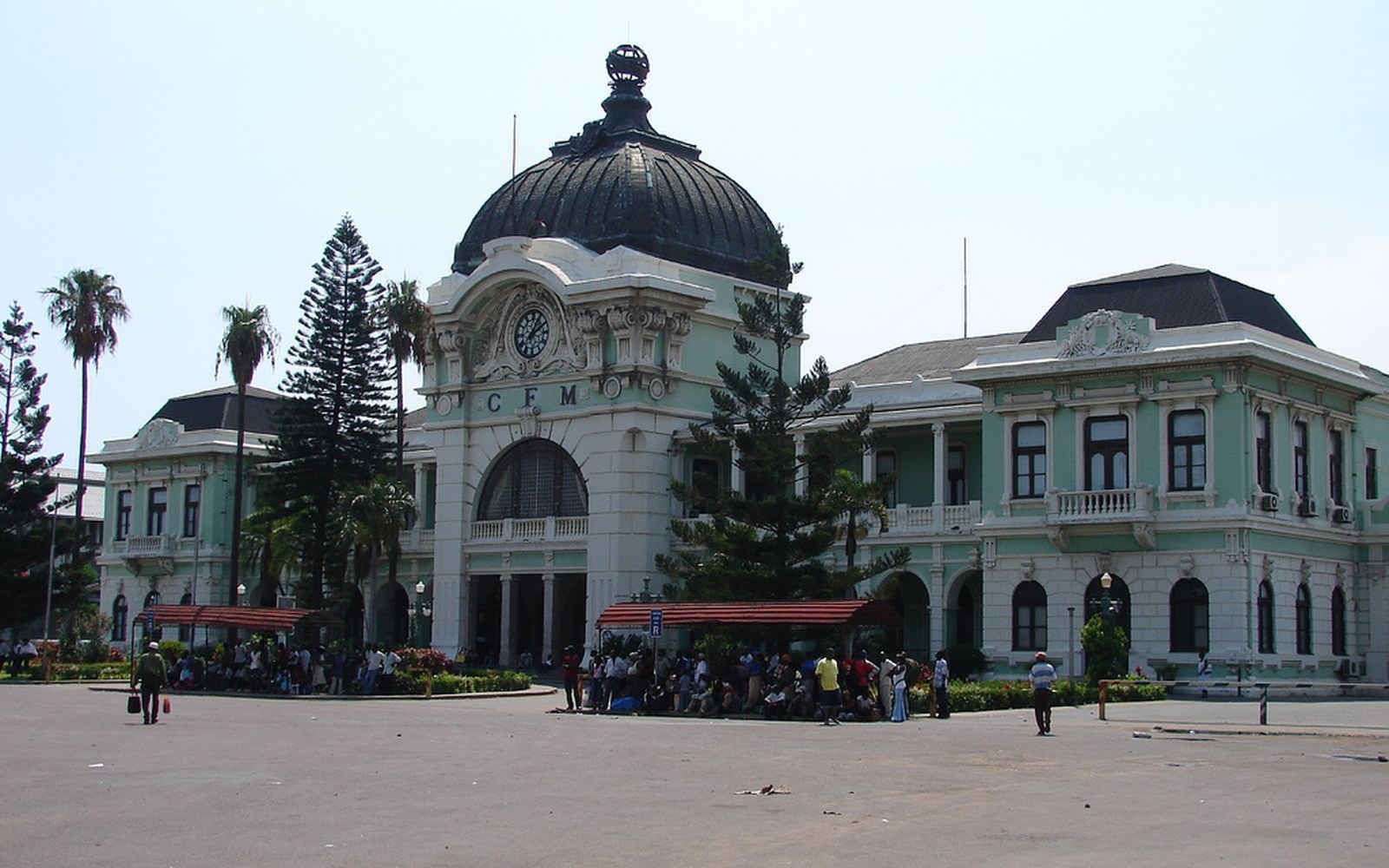 The CFM terminus in Maputo, copper dome above a green and white facade, crowds outside